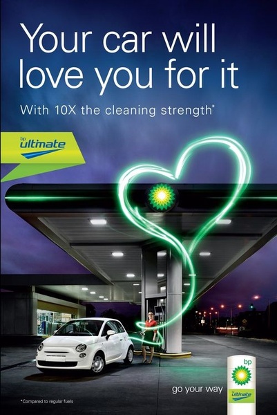 A clever visual metaphor shows a glowing heart connected from the gas pump to the car, symbolizing the care and cleaning power provided by the fuel.