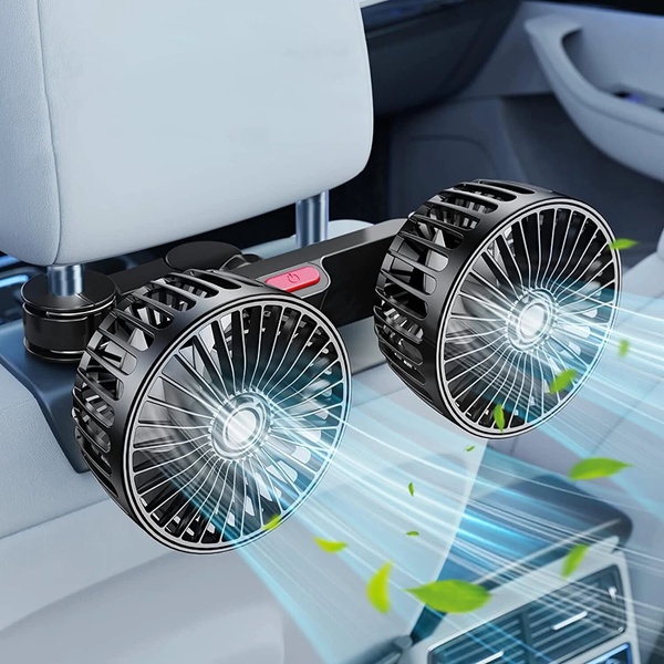 A close-up shot showing a dual-head electric car fan attached to a headrest, with visual lines indicating effective airflow.