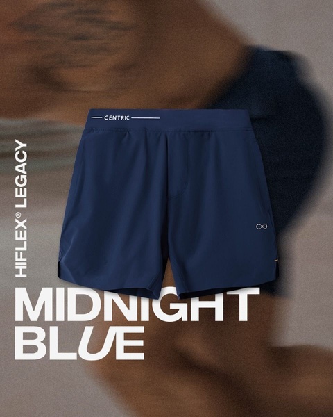 A clean, high-contrast ad showcasing athletic shorts in a solid midnight blue against a motion-blurred background.