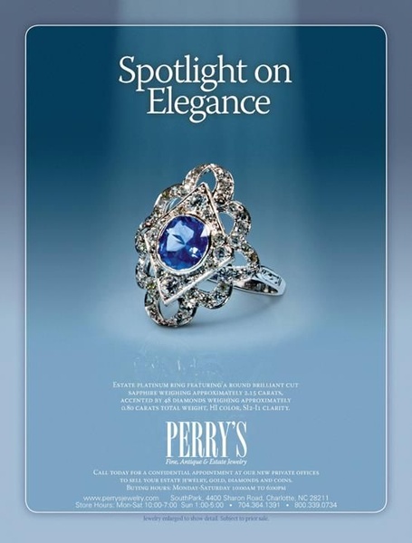 A refined, minimalist advertisement featuring a sapphire and diamond estate ring isolated under a soft spotlight to emphasize premium craftsmanship.