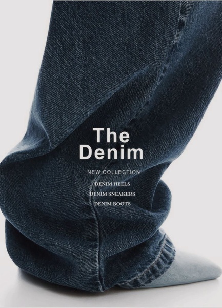 A clean, high-fashion close-up of denim fabric worn with a pointed heel, showcasing a new product line with minimalist typography.