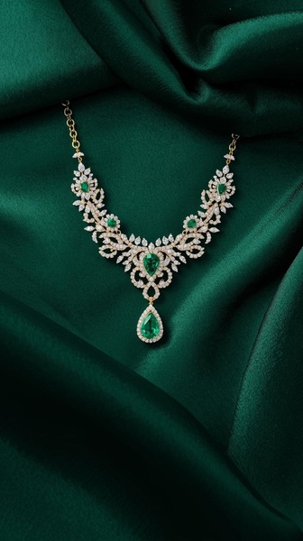 A high-end studio capture of a diamond and emerald necklace draped on deep green silk, focusing on elegance and product clarity.