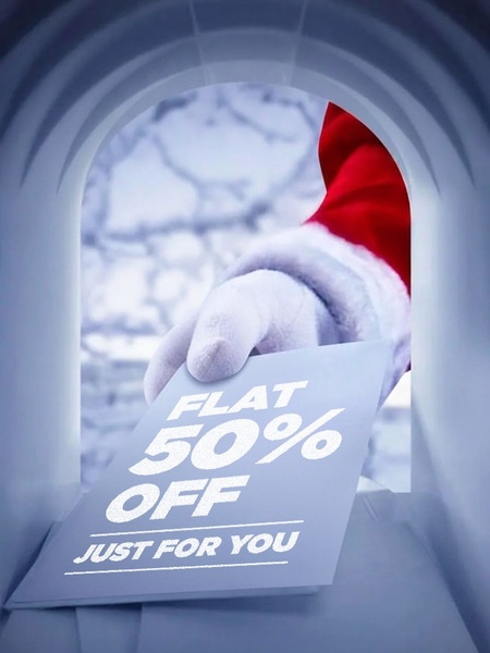 A festive, high-contrast creative showing a Santa-gloved hand delivering a 50% off discount offer through a mailbox.