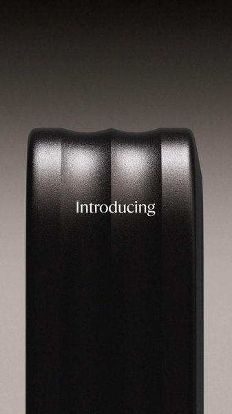 A high-contrast, moody close-up shot of an electronic gadget featuring a centered, simple 'Introducing' headline.