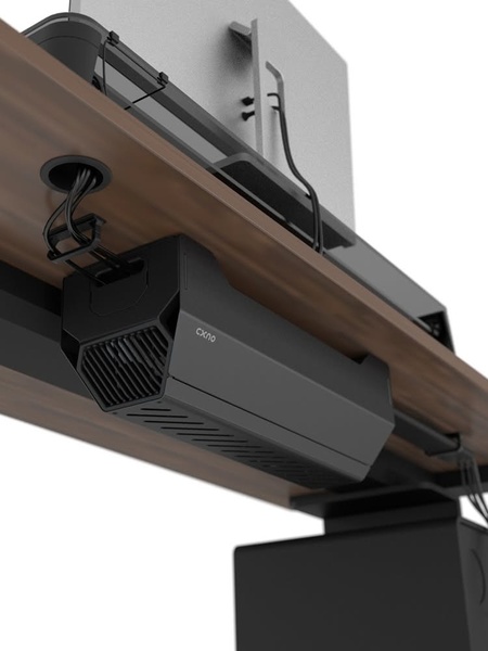 A high-angle, clean product shot of a black cable management tray mounted under a wood desk, demonstrating a tidy workspace solution.