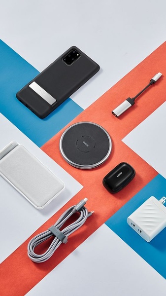 A clean, high-contrast flat lay of tech accessories organized on a geometric color-blocked background to emphasize product utility.