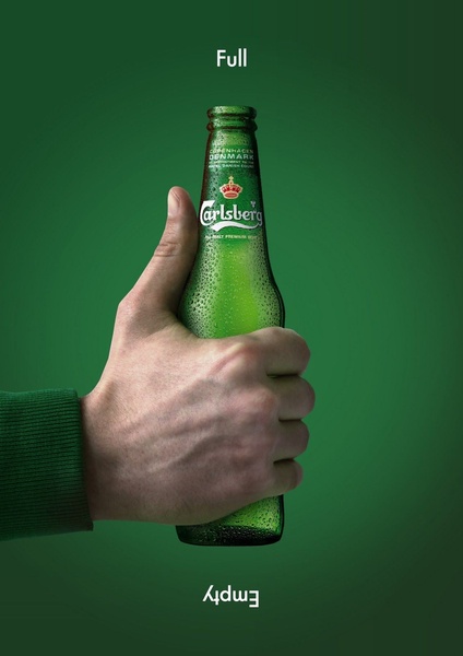 A high-contrast, minimalist creative featuring a beer bottle held in a hand, cleverly labeled 'Full' at the top and 'Empty' at the bottom to play with perspective.