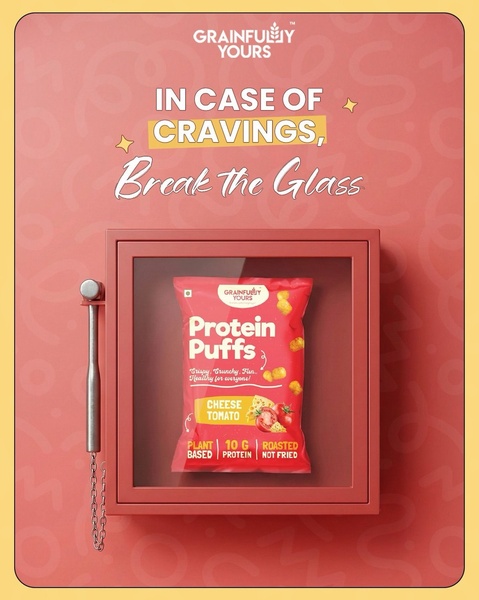 A clever, product-focused ad that treats a bag of protein puffs as a life-saving snack, displayed inside an emergency fire-style case.