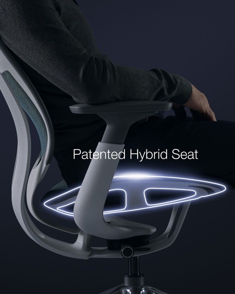 A close-up studio shot of an ergonomic office chair featuring a glowing highlight on the seat cushion to emphasize its patented design.
