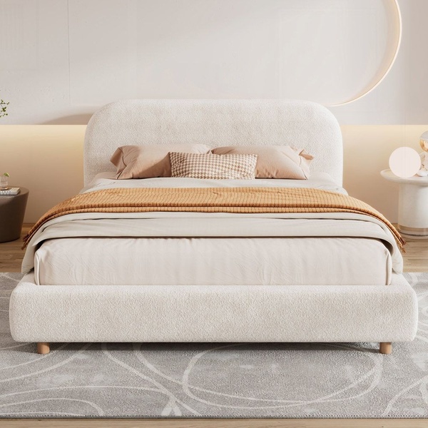 A high-quality, studio-lit photograph of a neutral-toned upholstered bed with a curved headboard, set in a serene, contemporary bedroom environment.