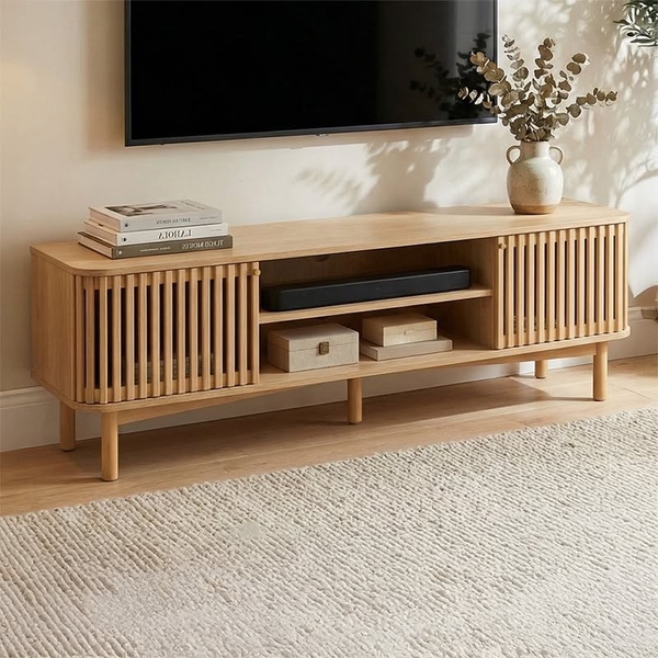 A high-quality, lifestyle-oriented hero shot of a wooden media console in a minimalist living room, styled with natural elements and neutral tones.