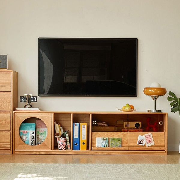 A high-quality, front-facing lifestyle shot of a wooden media console styled with daily items to demonstrate product utility and aesthetic integration.