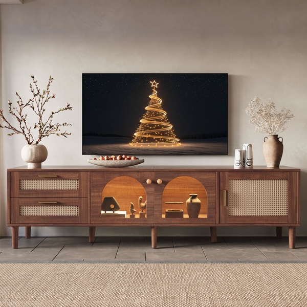 A high-end media console featuring a holiday-themed digital display, styled with curated decor in a warm, minimalist interior.