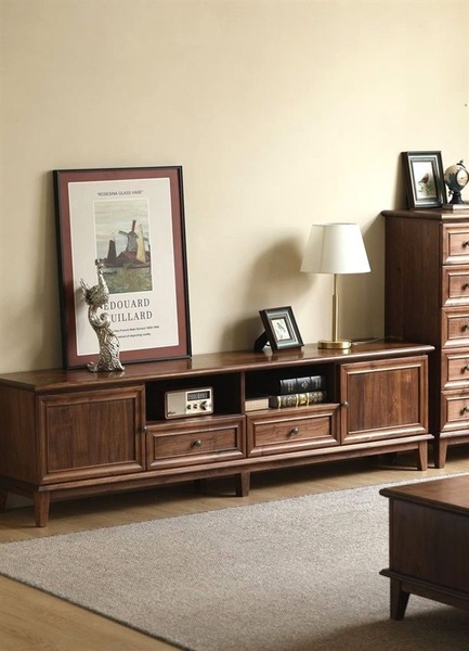 A high-quality, eye-level product hero shot featuring a rich-toned wooden TV stand in a warm, minimalist interior setting.