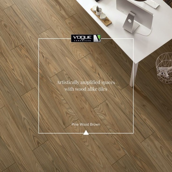 A high-angle architectural shot of Pine Wood Brown tiles featuring a clean, minimalist workspace environment and overlaid elegant typography.