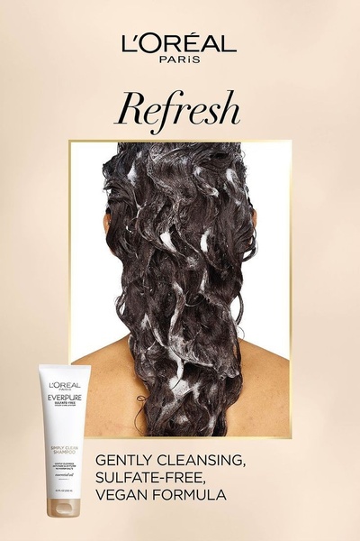 A minimalist, ingredient-focused advertisement featuring a back-view of a person's hair while lathering, showcasing product benefits.