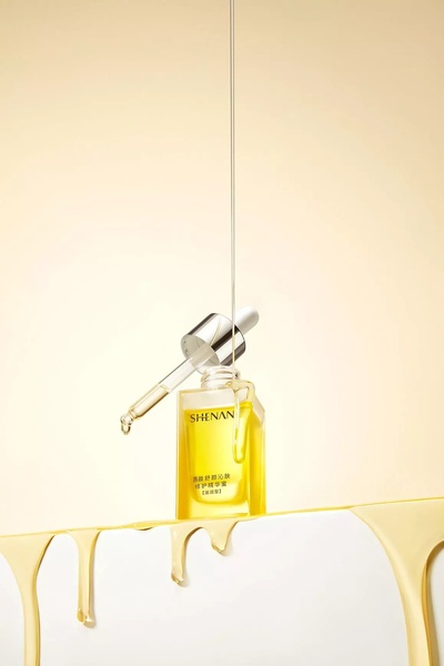 face serum, facial oil, skincare serum, dropper serum, beauty oil, product demo, minimalist, calm, luxurious, yellow, neutral