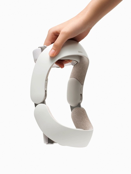 A clean, high-contrast hero shot of a white head massager device being held against a plain white background.