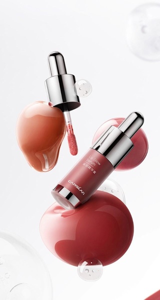 A high-end, clean studio shot of a lip serum bottle floating amidst serum droplets to emphasize texture and hydration.