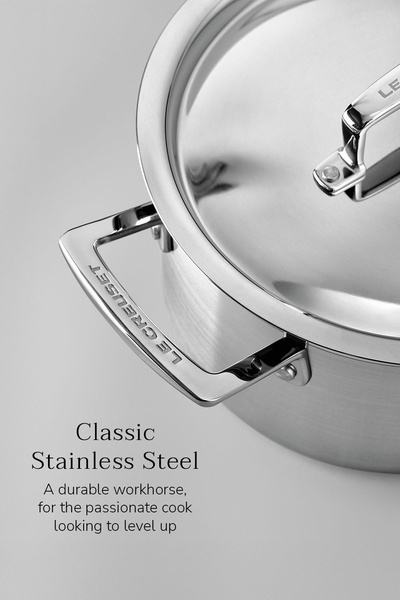 A high-detail, close-up shot of professional stainless steel cookware emphasizing build quality and minimalist aesthetic.