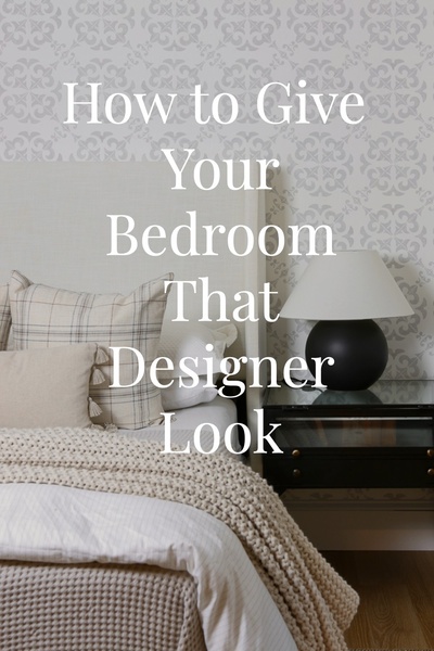 A high-quality, static image of a well-styled bedroom featuring neutral tones and elegant textures to showcase a high-end interior design aesthetic.