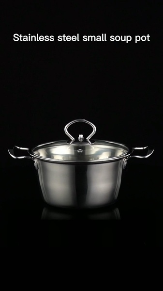 A high-quality product photography shot of a small stainless steel soup pot featuring a glass lid, centered against a pure black background.