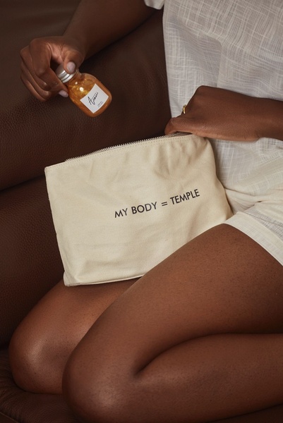 cosmetic pouch, toiletry bag, makeup bag, canvas zip pouch, beauty bag, travel pouch, brand awareness, new arrival, lifestyle, editorial, warm, luxurious, brown, neutral