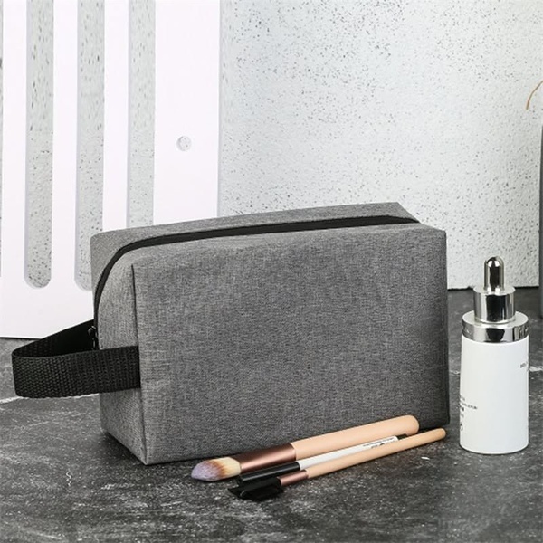 toiletry bag, travel makeup bag, cosmetic pouch, toiletry kit, travel storage bag, product demo, minimalist, calm, trustworthy, neutral