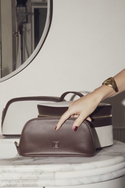 toiletry bag, makeup pouch, cosmetic case, toiletry kit, travel bag, new arrival, lifestyle, editorial, luxurious, calm, neutral, brown