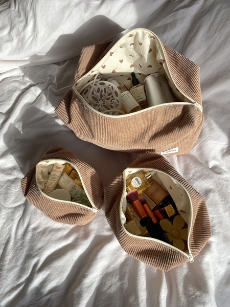 cosmetic bags, toiletry pouches, makeup bags, travel organizers, corduroy makeup bags, product demo, lifestyle, flat lay, calm, fresh, neutral, brown