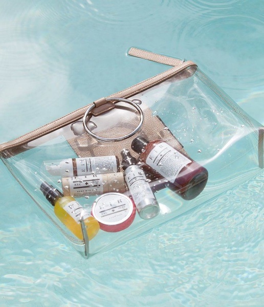 clear toiletry bag, travel makeup bag, transparent pouch, cosmetic organizer, clear travel pouch, product demo, lifestyle, fresh, calm, blue, neutral
