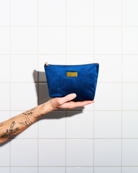 cosmetic bag, toiletry bag, makeup pouch, travel bag, small zip pouch, brand awareness, minimalist, lifestyle, calm, luxurious, blue, neutral