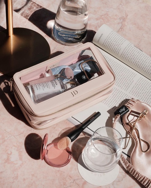 toiletry bag, cosmetic bag, makeup pouch, clear makeup bag, travel toiletry organizer, new arrival, flat lay, editorial, calm, luxurious, neutral, pastel, pink