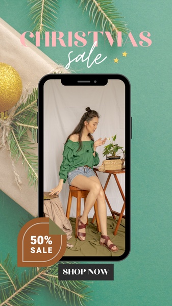 A vertical-format mobile mockup featuring a stylish blouse and sandals in a holiday-themed setting with a 50% discount call-to-action.