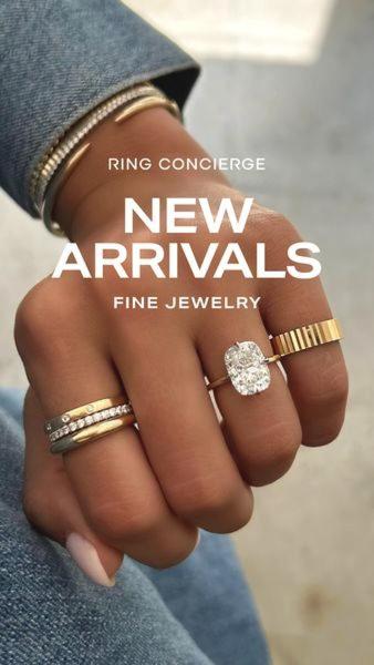 A close-up, high-quality photograph showcasing a curated stack of fine jewelry rings on a hand against a neutral background.