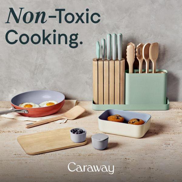 A top-down, balanced studio shot of a ceramic cookware set and kitchen utensils arranged on a stone surface with high-contrast text overlay.