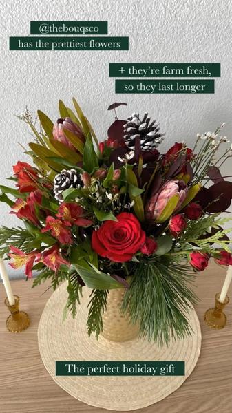 A close-up vertical shot of a festive holiday bouquet in a vase on a wooden surface, featuring text overlays that emphasize product benefits.