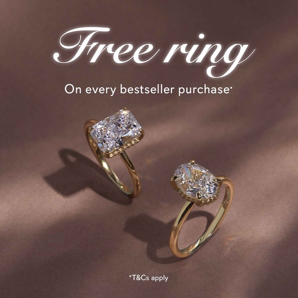 A clean, high-end product shot featuring two engagement rings on a neutral background, highlighting an incentive for bestseller purchases.