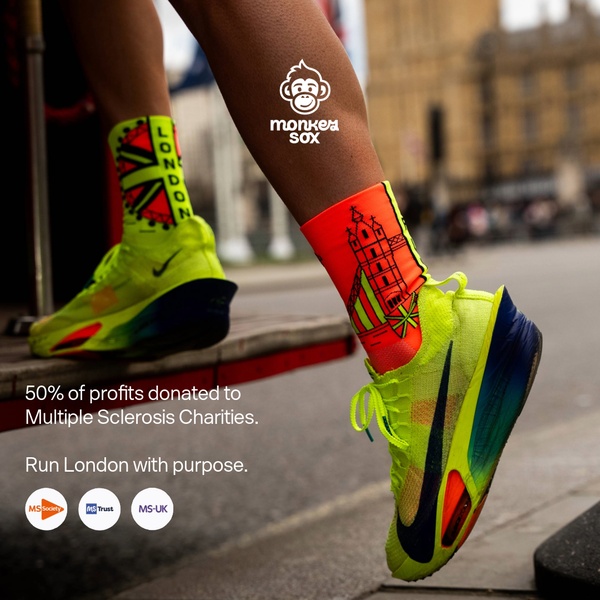 A close-up action shot of running socks featuring iconic London landmarks, highlighting a 50% profit donation to Multiple Sclerosis charities.