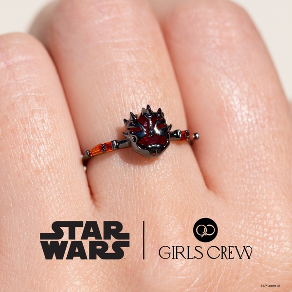 A detailed high-resolution product shot of a Star Wars themed ring on a finger, emphasizing the design and dark aesthetic.