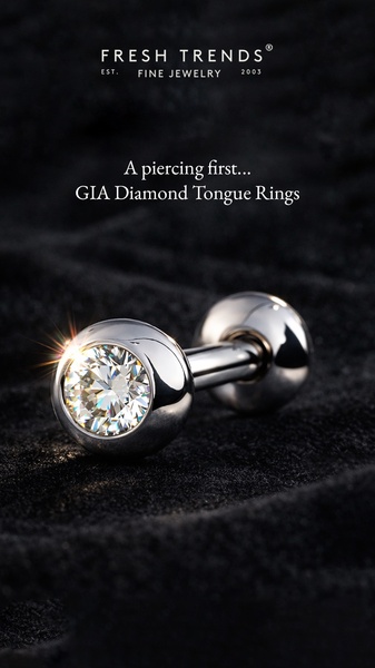A close-up studio shot of a diamond tongue ring set against a dark textured background, emphasizing luxury and precision.