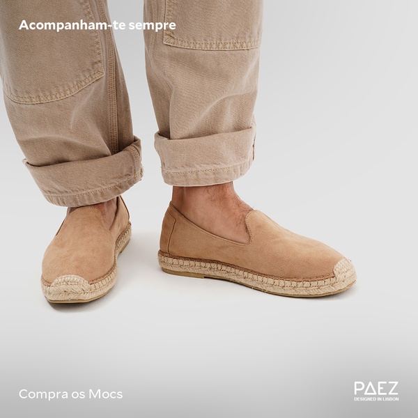 A close-up, high-key shot focusing on the footwear's texture and silhouette against a plain studio background.
