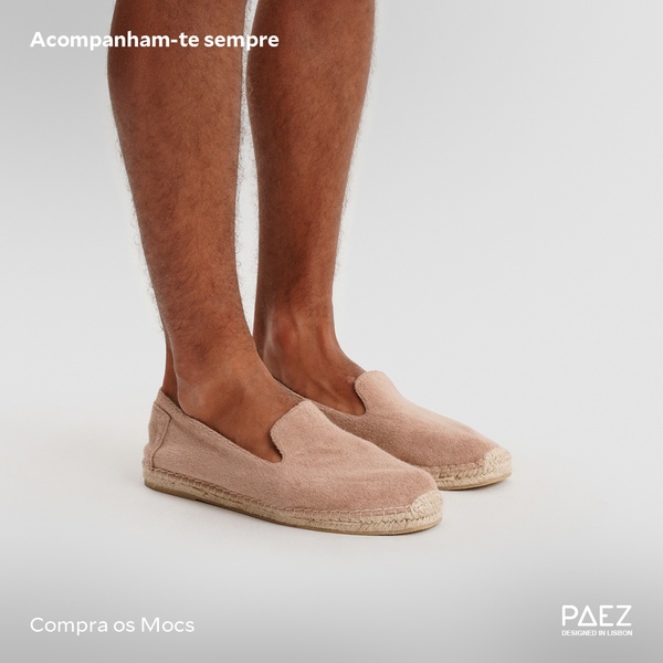 A clean, high-contrast studio shot of a pair of neutral-toned espadrilles worn on a model, focusing on product comfort and wearability.