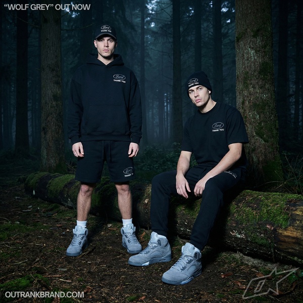 A dark, moody, forest-set campaign featuring models wearing coordinating streetwear apparel pieces and footwear.