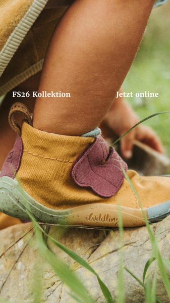 A close-up, macro-style product photograph of a child wearing barefoot-style footwear, emphasizing texture and materials in a natural setting.
