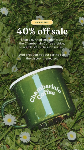 A top-down nature-inspired shot of an enamel coffee mug placed in grass, used to promote a curated archive sale.