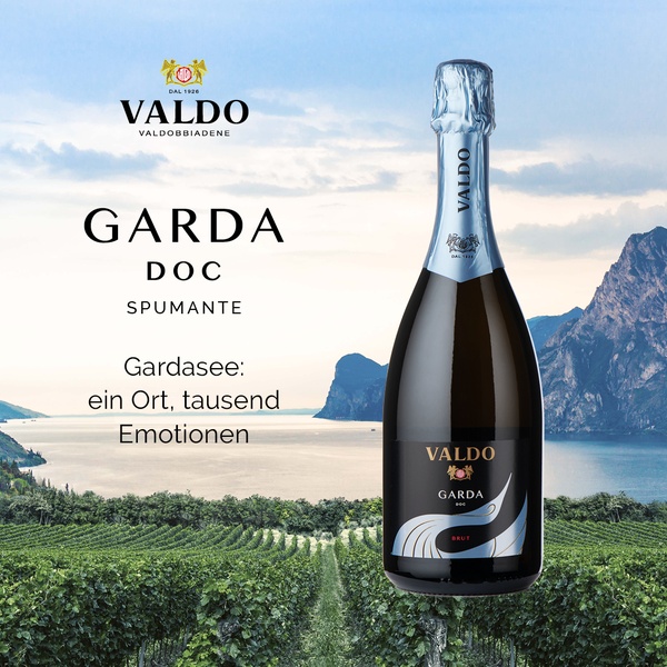 A high-quality product shot of a bottle of Spumante placed against a scenic vineyard and lake background, creating an aspirational atmosphere.