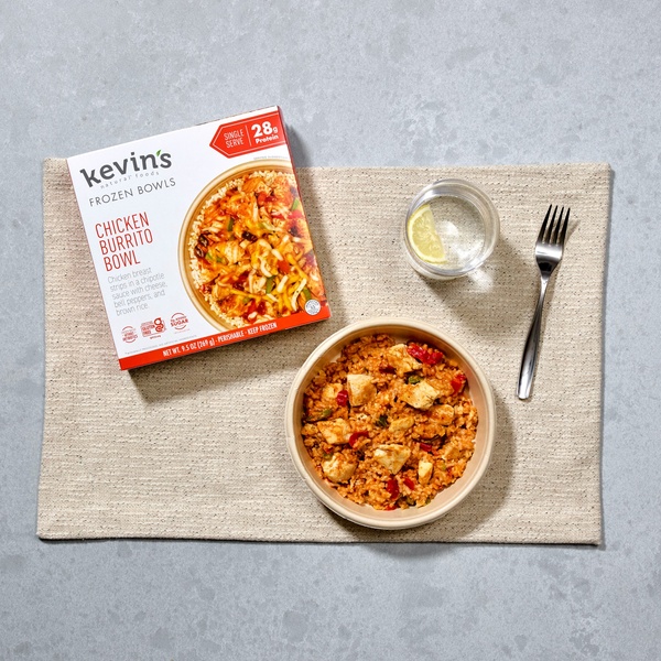 A high-quality 1:1 ratio photograph featuring the product packaging beside the prepared meal on a neutral textured placemat.