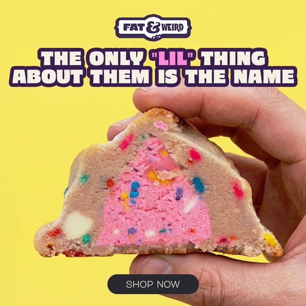 A close-up, high-contrast shot of a gourmet cookie cross-section, showing the interior texture and color against a vibrant yellow background.