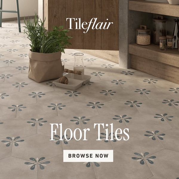 A 1:1 square ad featuring patterned floor tiles in a kitchen setting with natural lighting and a clean, branded call-to-action.